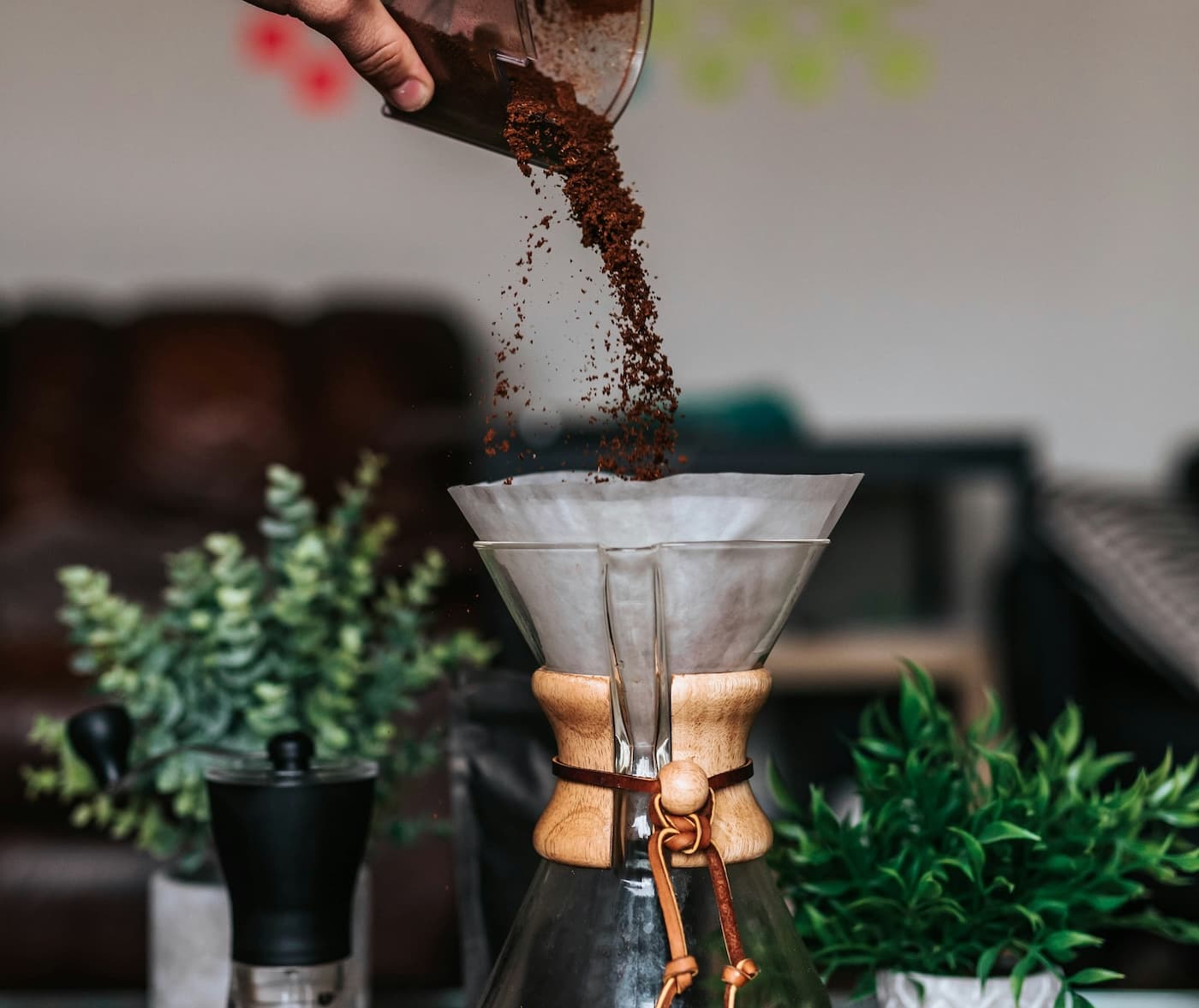 Ground coffee being poured into a Chemex from a height