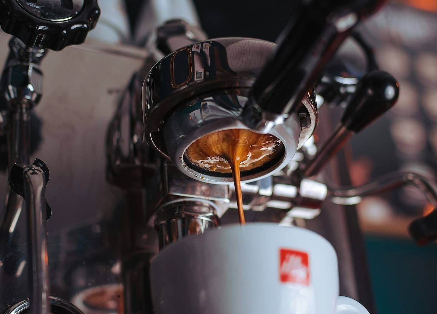 Under-shot of an espresso machine, pouring espresso